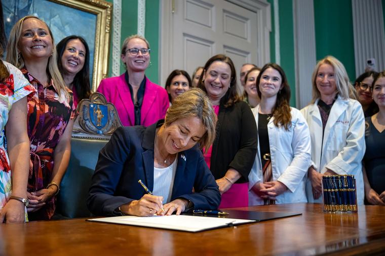 Massachusetts Gov. Maura Healey, joined by state officials and advocates, signs legislation expanding access to abortion at the Massachusetts State House in Boston on Aug. 10, 2026.