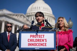 Chloe Cole speaks as Rep. Marjorie Taylor Greene (R-GA) looks on during a news conference on Capitol Hill September 20, 2022 in Washington, DC.