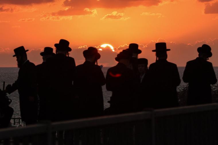 Orthodox Jewish men perform the “Tashlich” ritual, during which “sins are cast into the water to the fish,” in Israel's coastal city of Netanya, on Sept. 30, 2025, ahead of the Day of Atonement, or Yom Kippur, the most important day in the Jewish religious calendar.